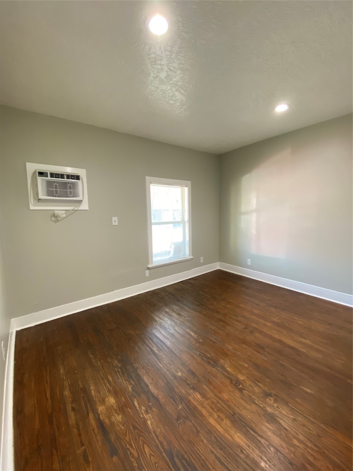 706 Dumble Street Houston, TX 77023 - Photo 11 of 13 an empty room with wooden floor and windows