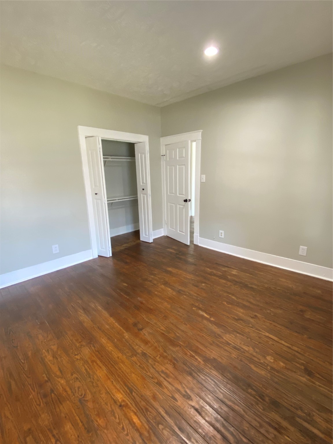 706 Dumble Street Houston, TX 77023 - Photo 12 of 13 an empty room with wooden floor and windows