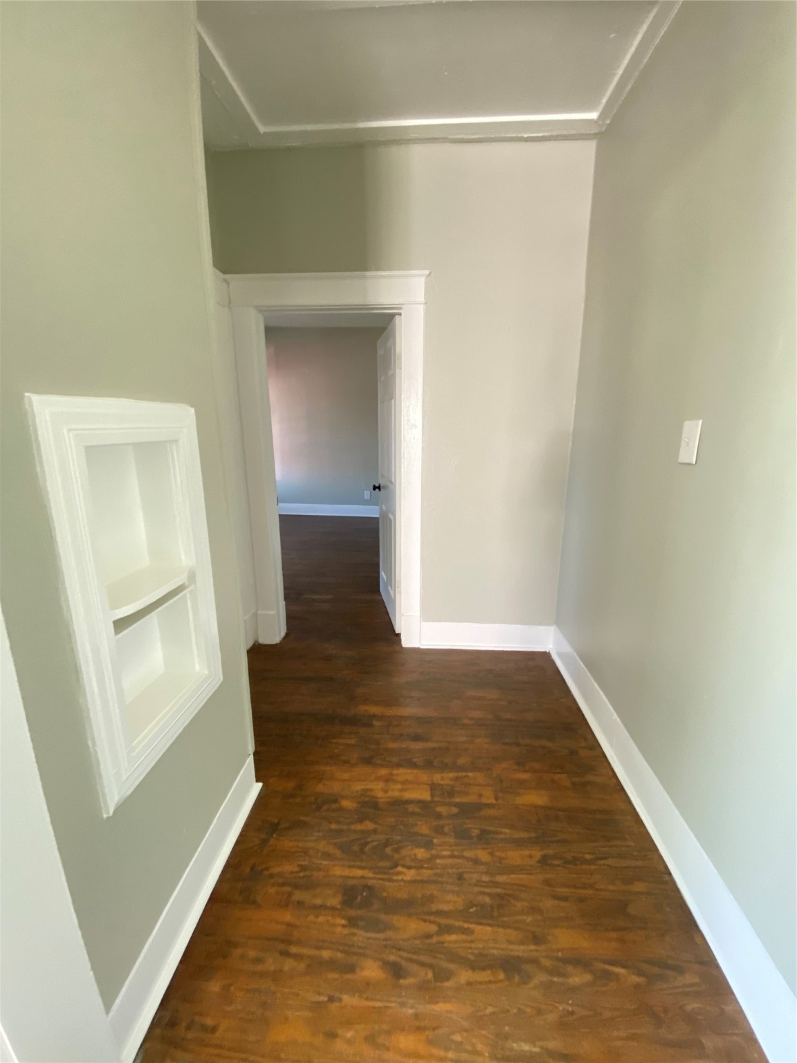 706 Dumble Street Houston, TX 77023 - Photo 9 of 13 a view of an empty room with wooden floor and a window