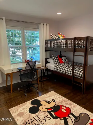 a living room with furniture a rug and a floor to ceiling window