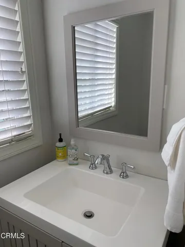 a bathroom with a sink and a window