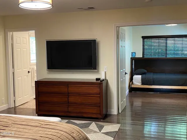 a bedroom with a bed and a television