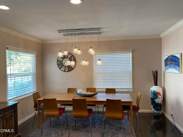 a dining room with a table and chairs
