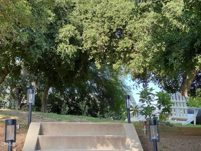 a wooden bench sitting in the middle of a yard