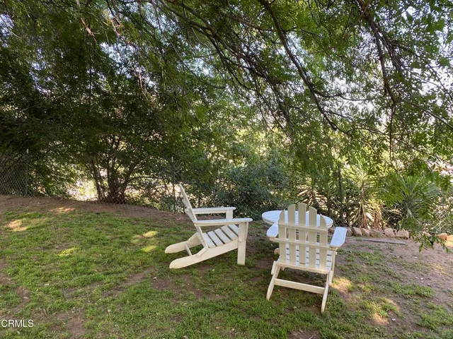 a view of a chairs and table in the garden