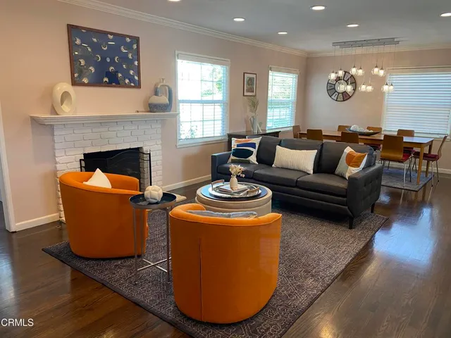 a living room with furniture a fireplace and window