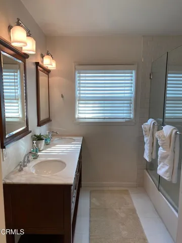 a bathroom with a sink vanity and a mirror