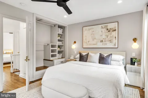 a bedroom with a bed and a painting on the wall