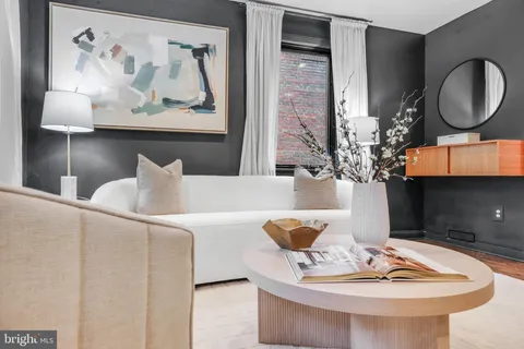 a living room with furniture and a lamp