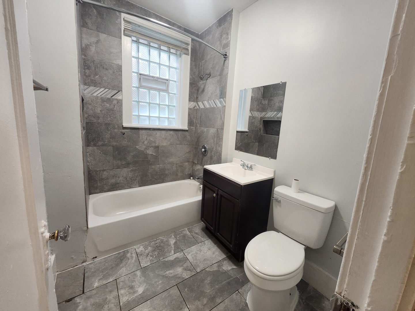 7412 South Prairie Avenue, Unit 1F Chicago, IL 60619 - Photo 5 of 9 a bathroom with a sink toilet and shower