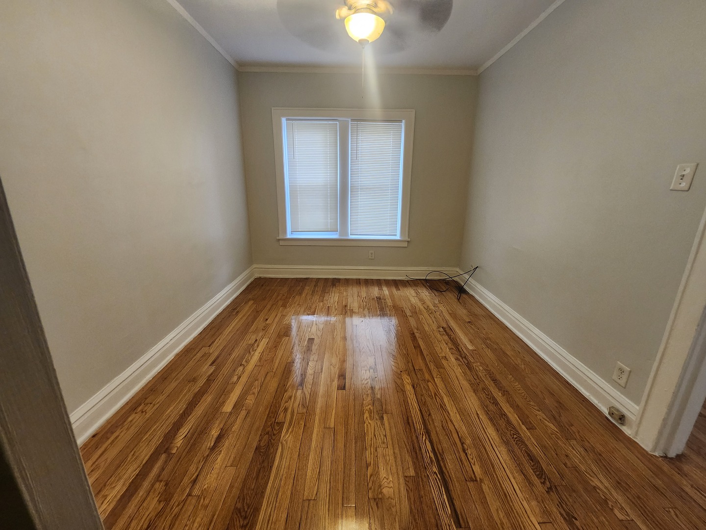 7412 South Prairie Avenue, Unit 1F Chicago, IL 60619 - Photo 6 of 9 a view of a room with wooden floor and window