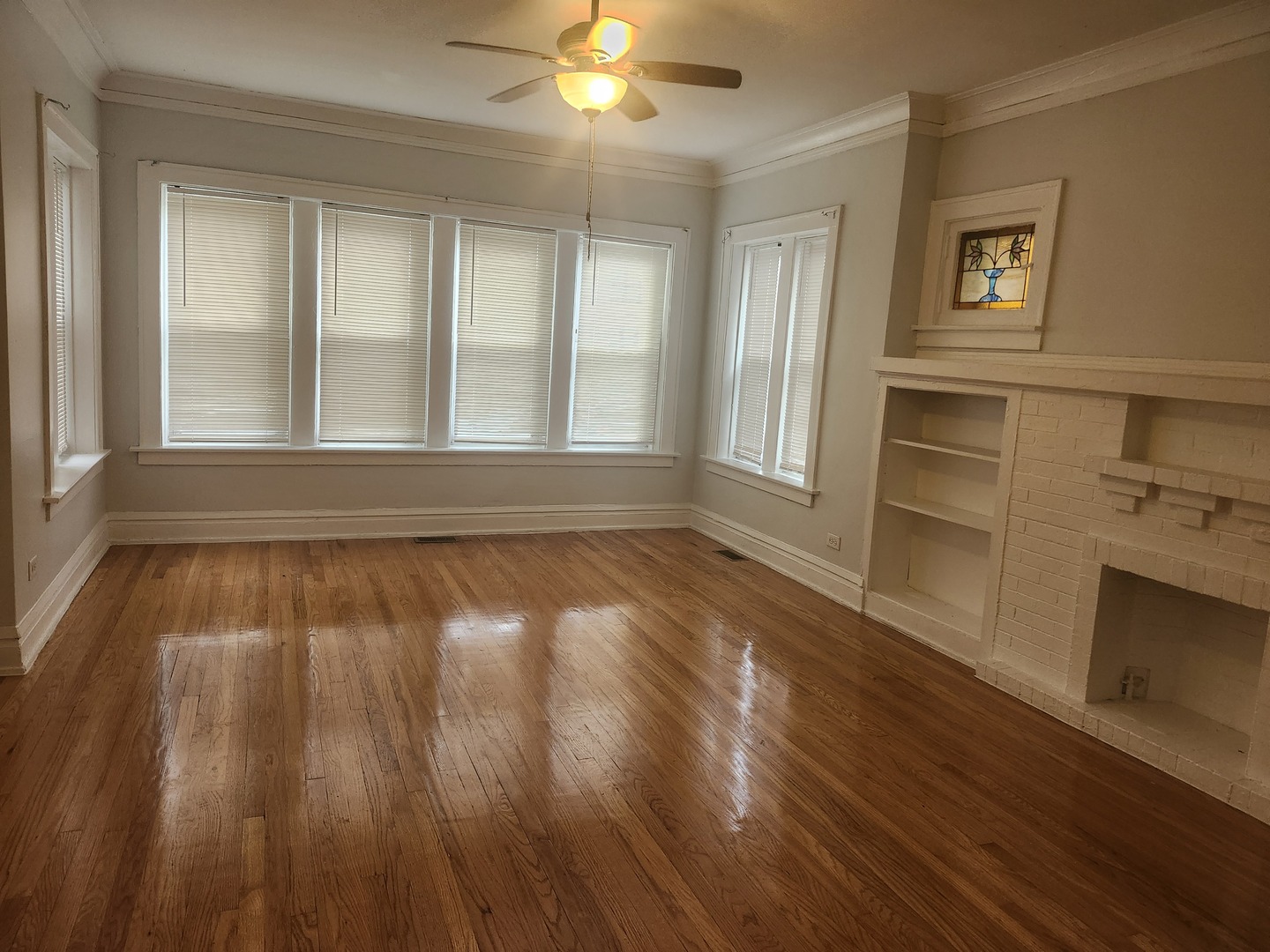 7412 South Prairie Avenue, Unit 1F Chicago, IL 60619 - Photo 9 of 9 wooden floor in an empty room with a window