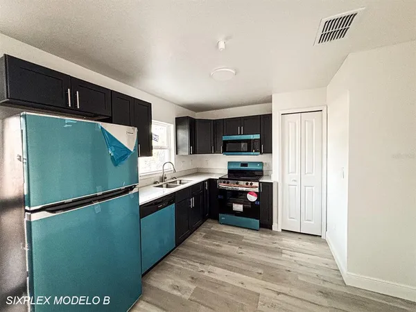 a kitchen with stainless steel appliances granite countertop a refrigerator and a sink