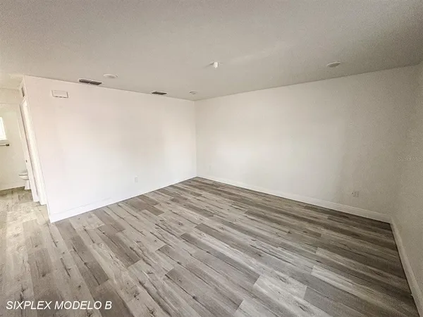 a view of a room with wooden floor