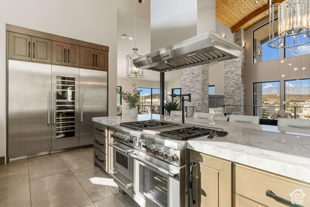 3652 South Cypress Road Hurricane, UT 84737 - Photo 38 of 81 Gourmet kitchen with professional-grade stainless steel appliances, large center island with cooktop, built-in wine refrigerator, and high vaulted ceilings with wood-paneled accents