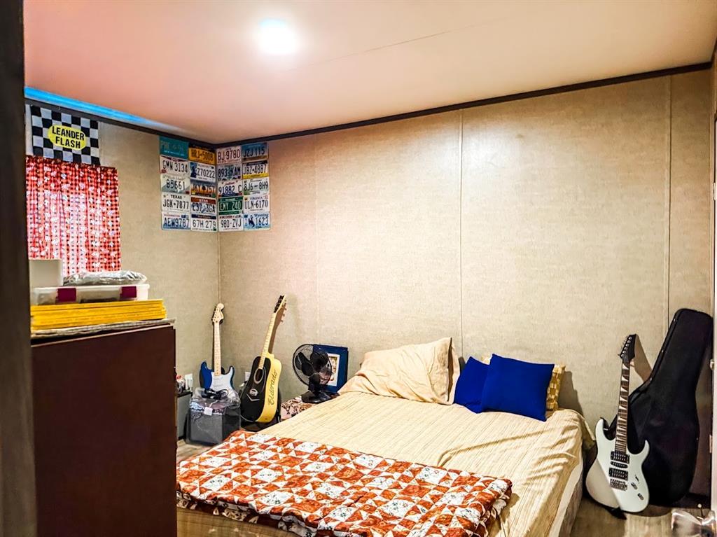 891 Tbd County Road Jewett, TX 75846 - Photo 14 of 22 a bedroom with a bed and wooden floor