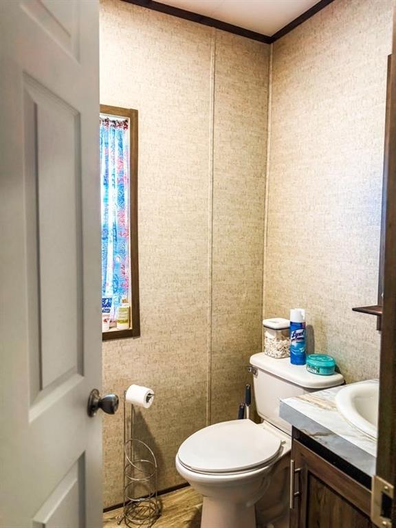 891 Tbd County Road Jewett, TX 75846 - Photo 15 of 22 a white toilet sitting next to a bathroom sink