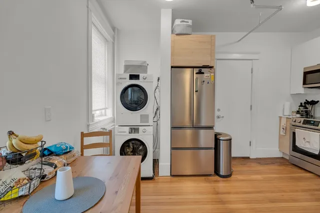 a view of kitchen cabinetry and wooden floor