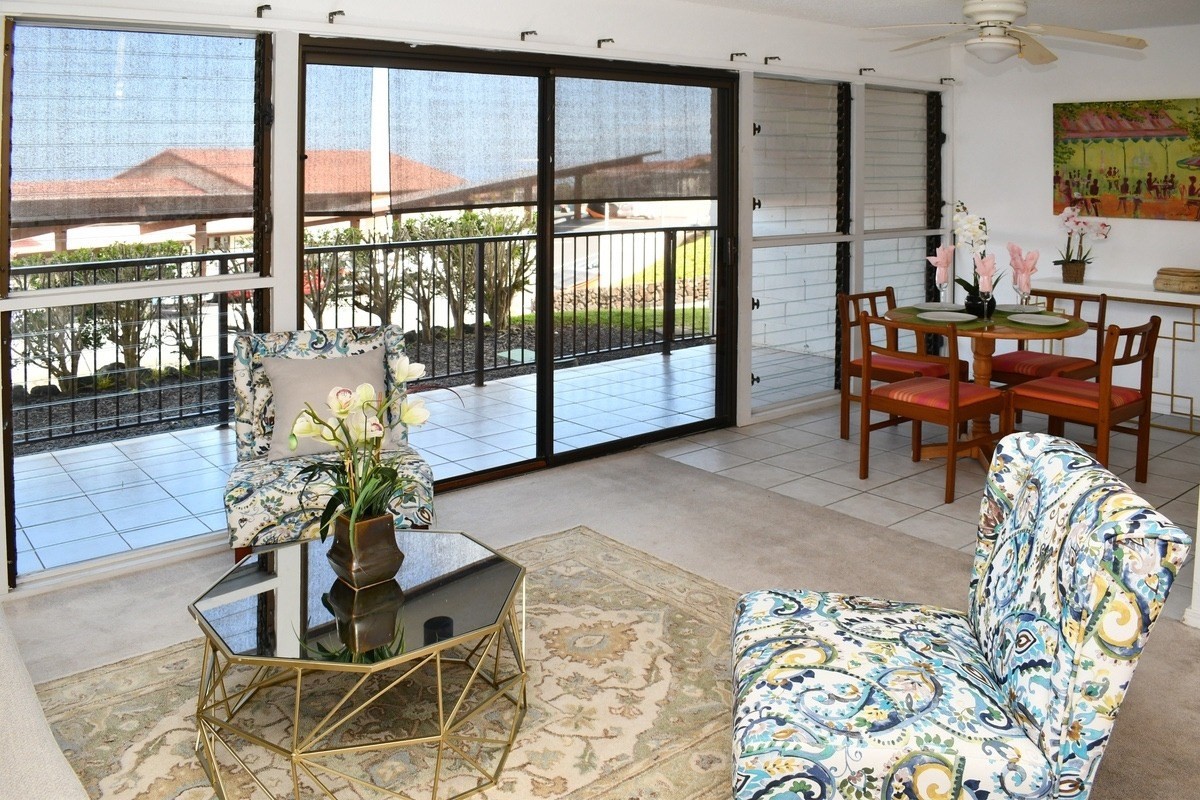 a living room filled with furniture and a potted plant