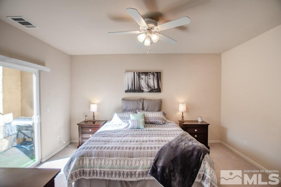 9050 Double R Boulevard, Unit NV Reno, NV 89521 - Photo 13 of 25 a bedroom with a bed and a chandelier