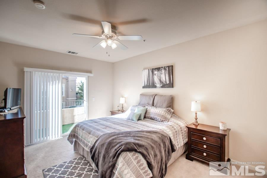 9050 Double R Boulevard, Unit NV Reno, NV 89521 - Photo 14 of 25 a bedroom with a bed and a chandelier