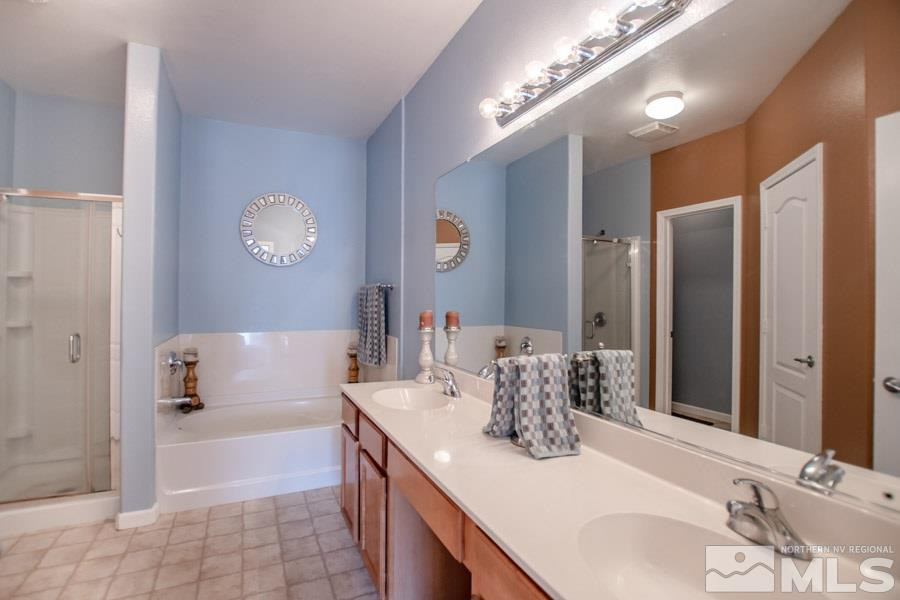 9050 Double R Boulevard, Unit NV Reno, NV 89521 - Photo 15 of 25 a bathroom with a tub sink and mirror