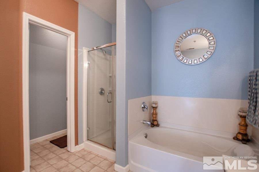 9050 Double R Boulevard, Unit NV Reno, NV 89521 - Photo 16 of 25 a bathroom with a bathtub and a shower