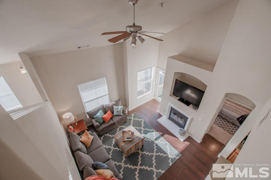 9050 Double R Boulevard, Unit NV Reno, NV 89521 - Photo 20 of 25 a living room with furniture a flat screen tv and a fireplace