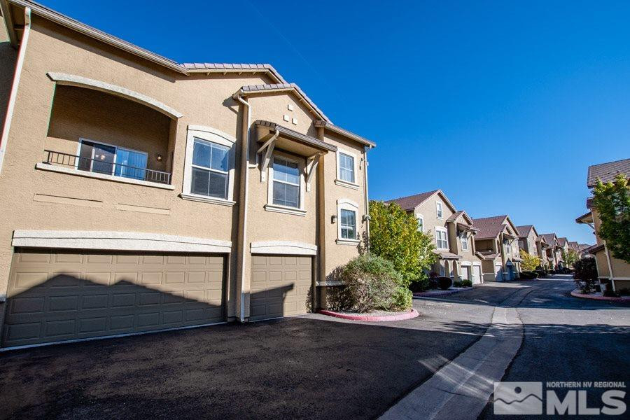 9050 Double R Boulevard, Unit NV Reno, NV 89521 - Photo 2 of 25 a front view of a house with plants