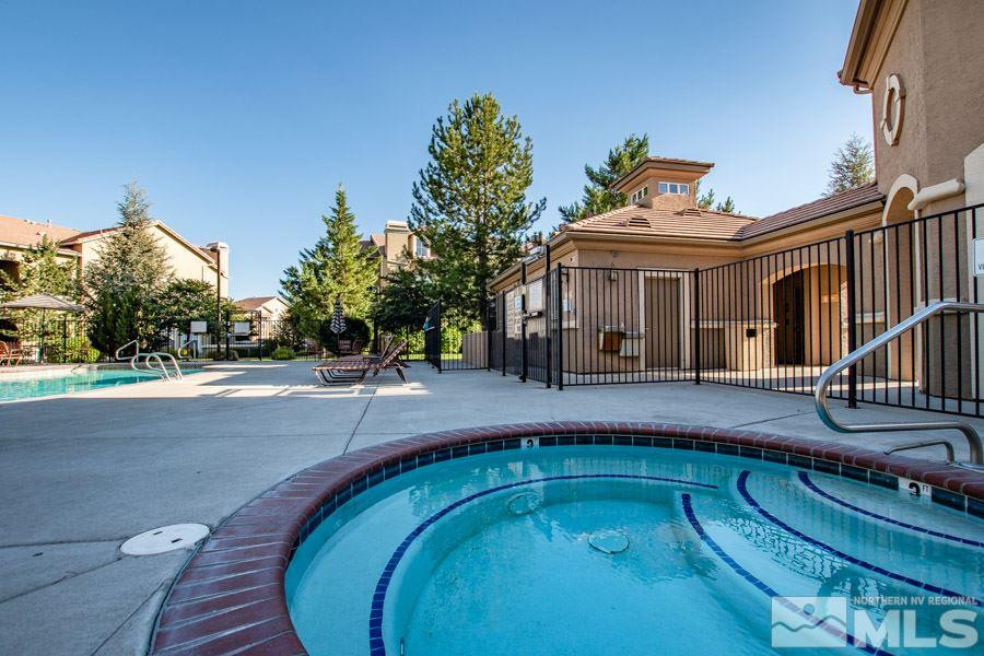 9050 Double R Boulevard, Unit NV Reno, NV 89521 - Photo 23 of 25 a view of a house with pool and trees