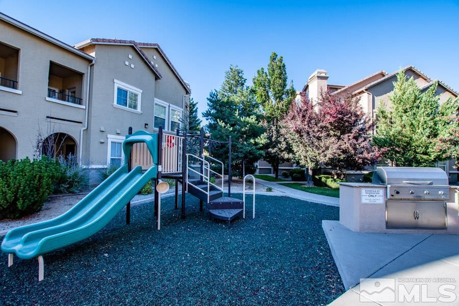9050 Double R Boulevard, Unit NV Reno, NV 89521 - Photo 24 of 25 a backyard of a house with table and chairs