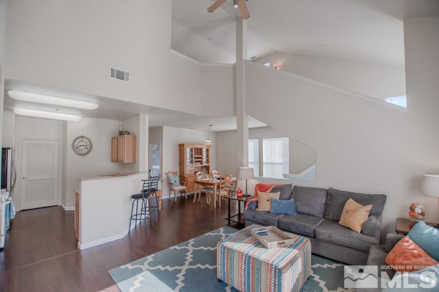 9050 Double R Boulevard, Unit NV Reno, NV 89521 - Photo 4 of 25 a living room with furniture kitchen view and a wooden floor