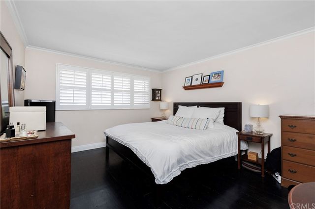 a bedroom with a bed and dresser