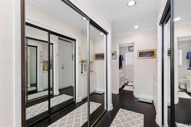 a view of a hallway with a livingroom and dining room