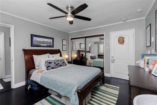 a bedroom with a large bed a desk and chair