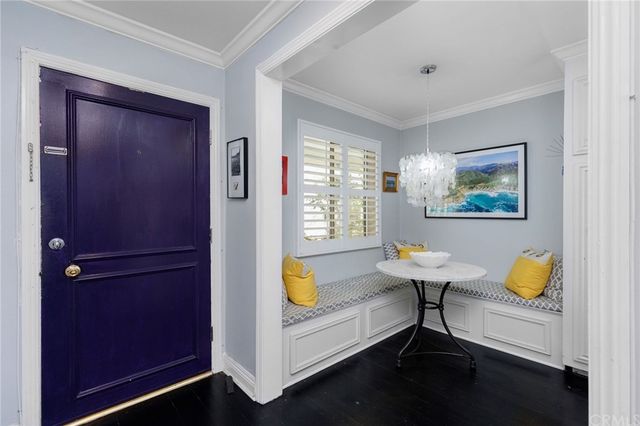 a living room with dining table and a window
