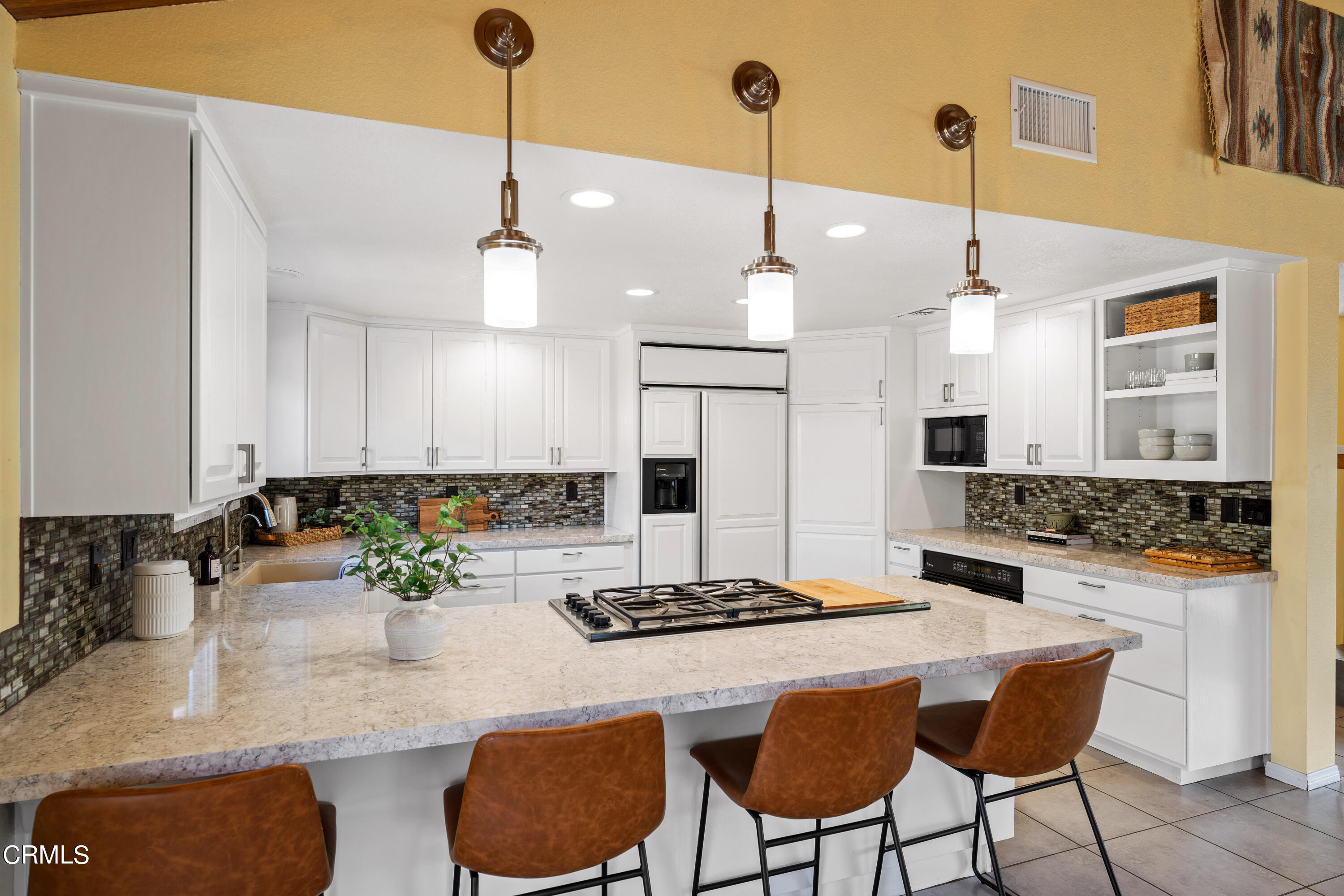 531 Ridgeline Drive Oak View, CA 93022 - Photo 12 of 36 a kitchen with a dining table chairs and granite counter tops