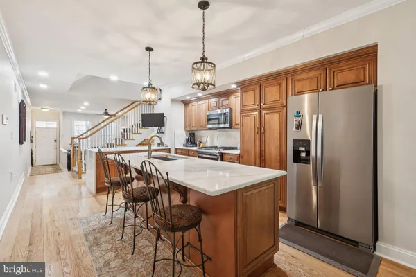 a kitchen with a sink a counter top space and stainless steel appliances
