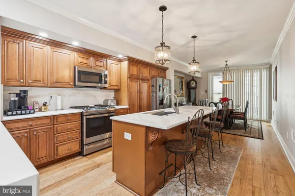 a view of a dining room with furniture and a chandelier