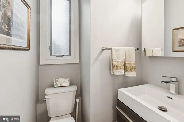 a living room with furniture and a view of kitchen