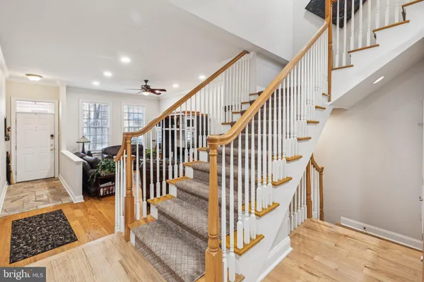 a living room with furniture a wooden floor and a flat screen tv