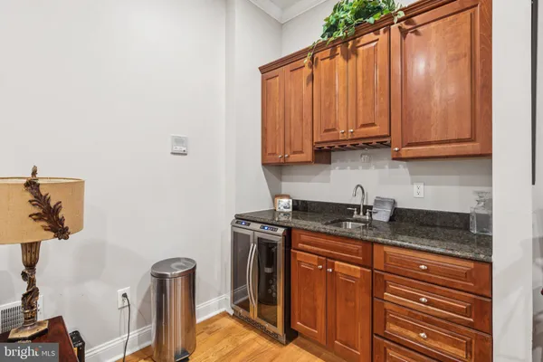 a bathroom with a sink a toilet a mirror and shower