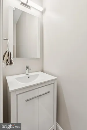 a view of staircase with wooden floor and white walls