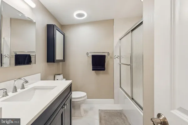 a bathroom with a shower and a sink