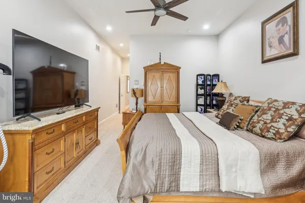 a view of a hallway with closet and a bathroom