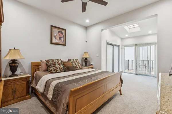 a bathroom with a sink a toilet a mirror and shower