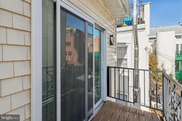 a view of a balcony with wooden floor and city view