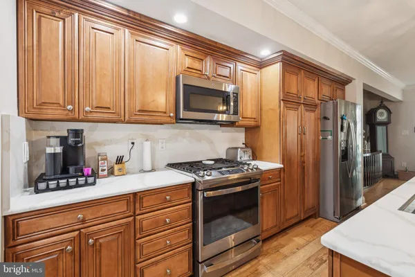 a kitchen with stainless steel appliances a sink stove and refrigerator