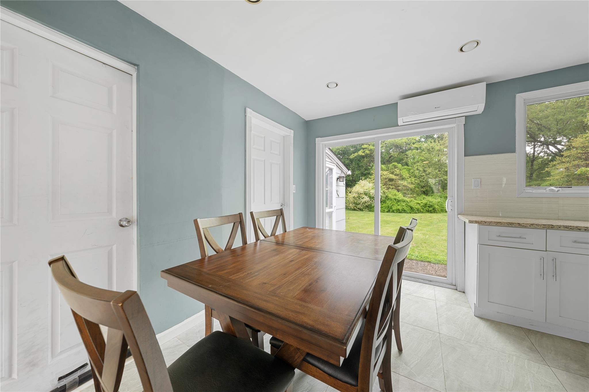 51 Joline Road Port Jefferson Station, NY 11776 - Photo 16 of 38 a view of a dining room with furniture window and outside view