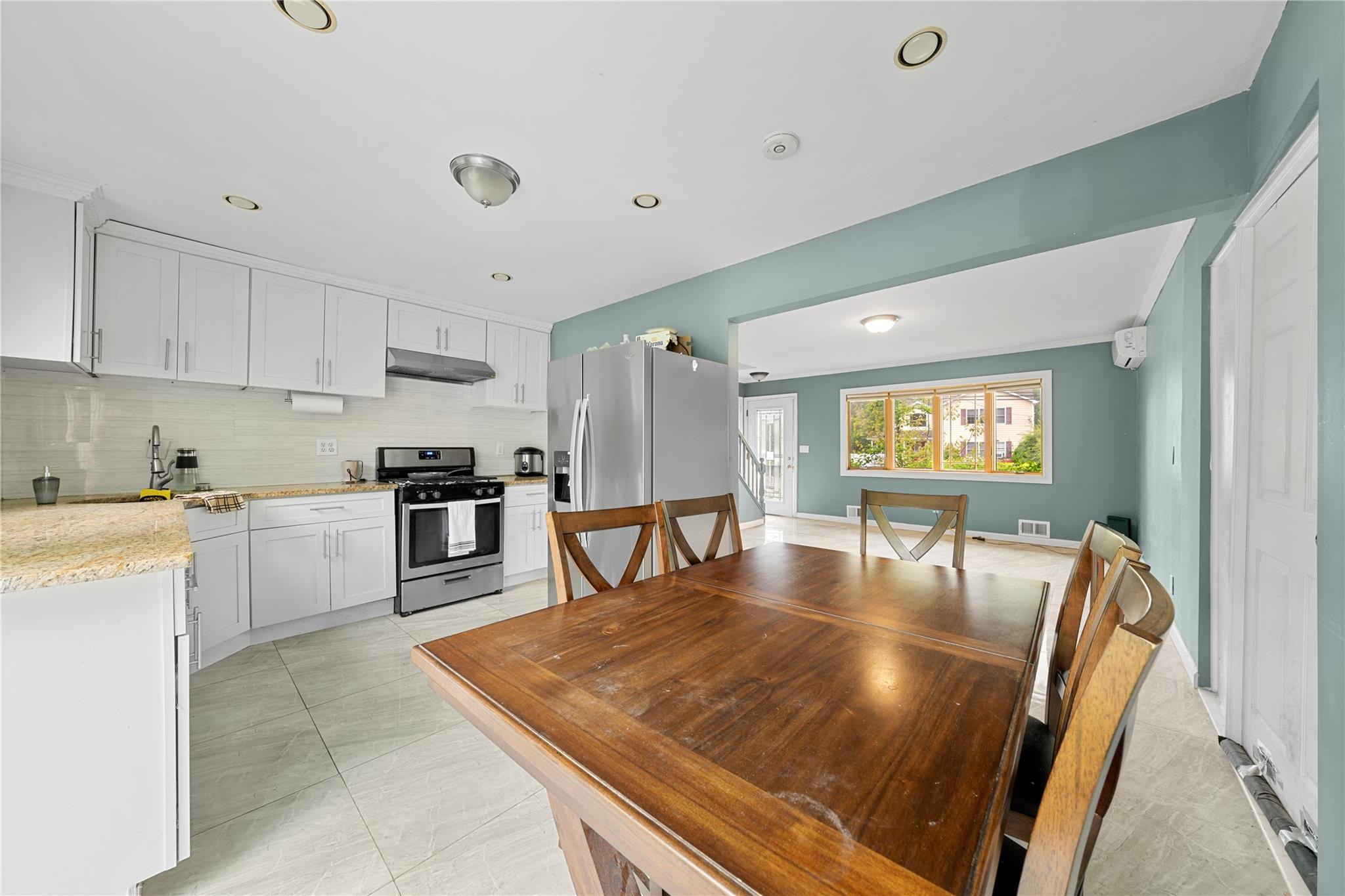 51 Joline Road Port Jefferson Station, NY 11776 - Photo 17 of 38 a kitchen with stainless steel appliances granite countertop a stove refrigerator and cabinets